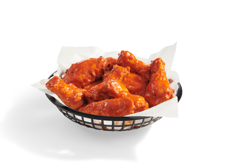 A full basket of crispy, bone-in chicken wings coated in hot Buffalo sauce.