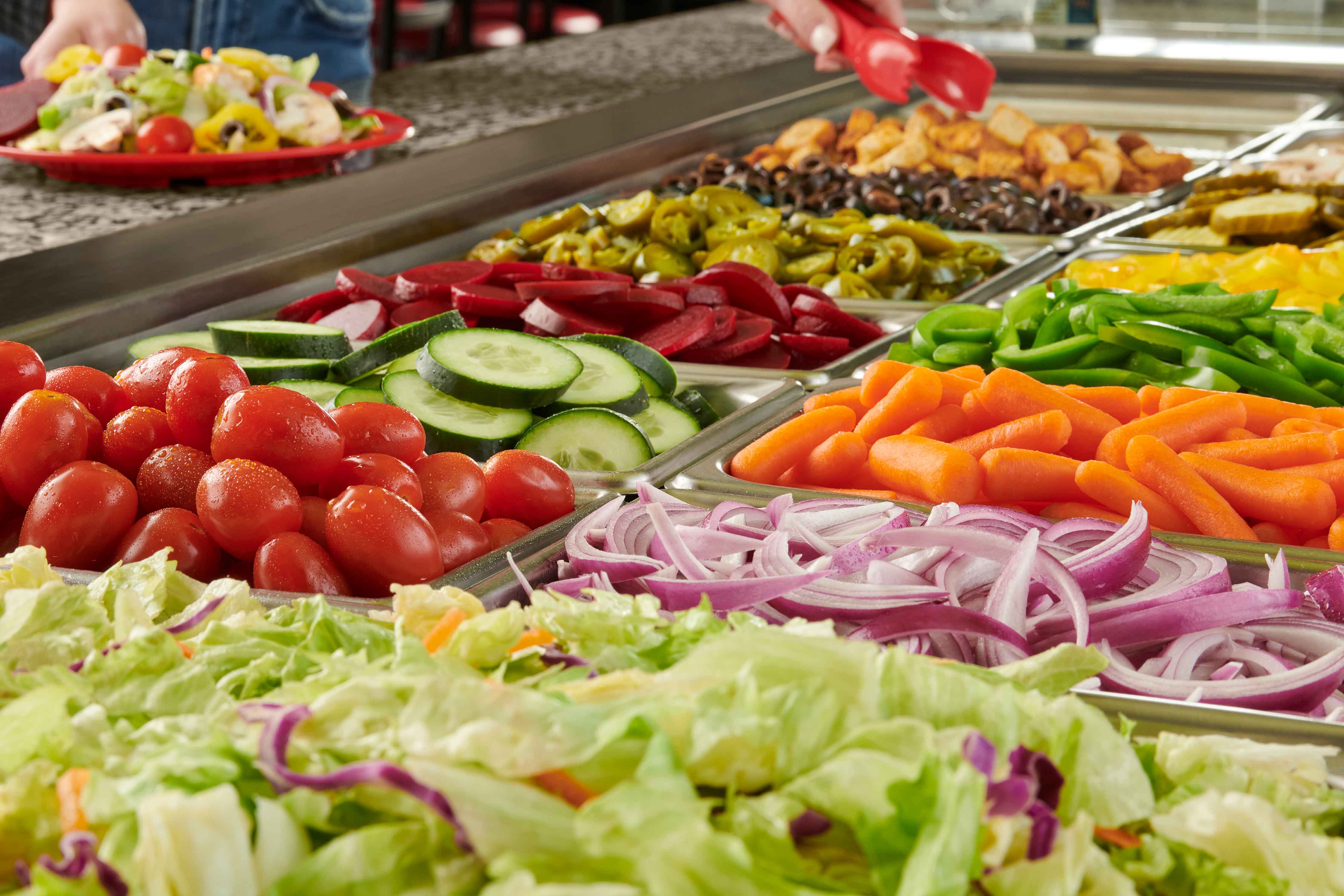 A view of different salads on salad buffet trays