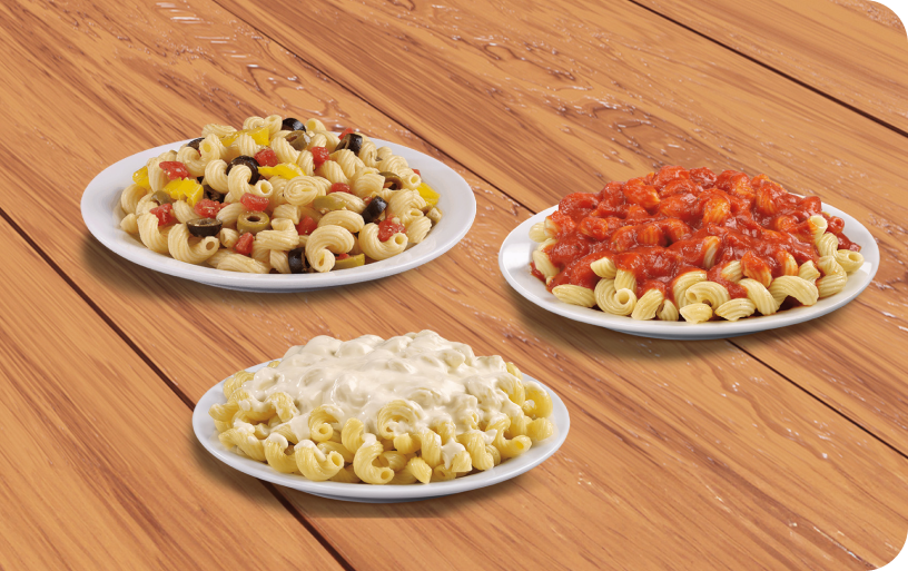 Three pasta dishes on a wood table