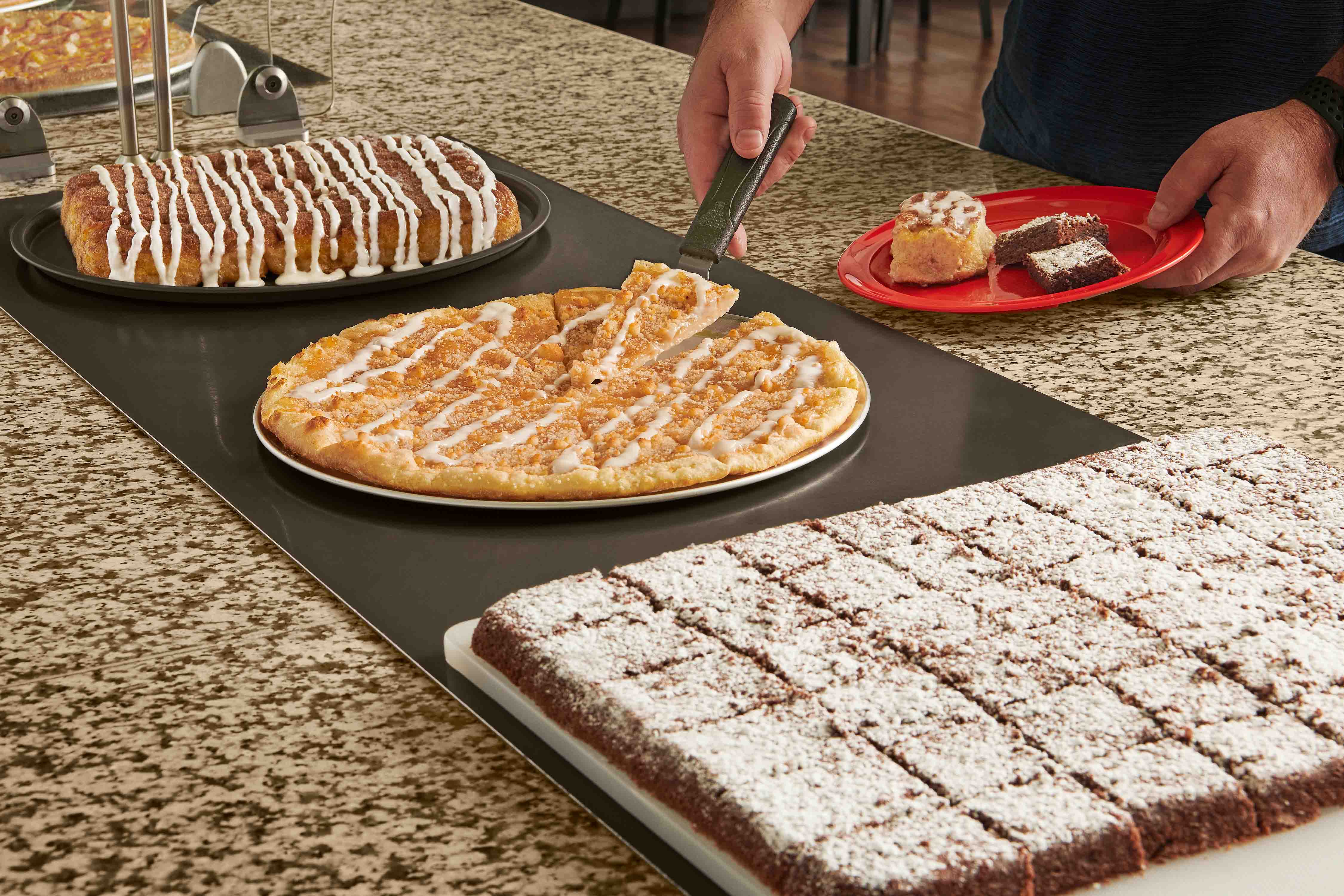 Apple dessert pizza getting served on a plate